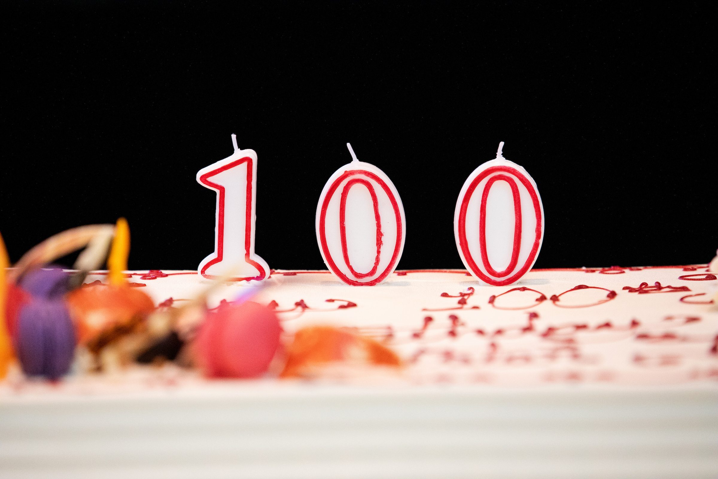 A 100 birthday candle sits atop a birthday cake for Sister Jean Dolores-Schmidt on her 100th birthday celebration in the Damen Student Center on August 21, 2019. (Photo: Lukas Keapproth)