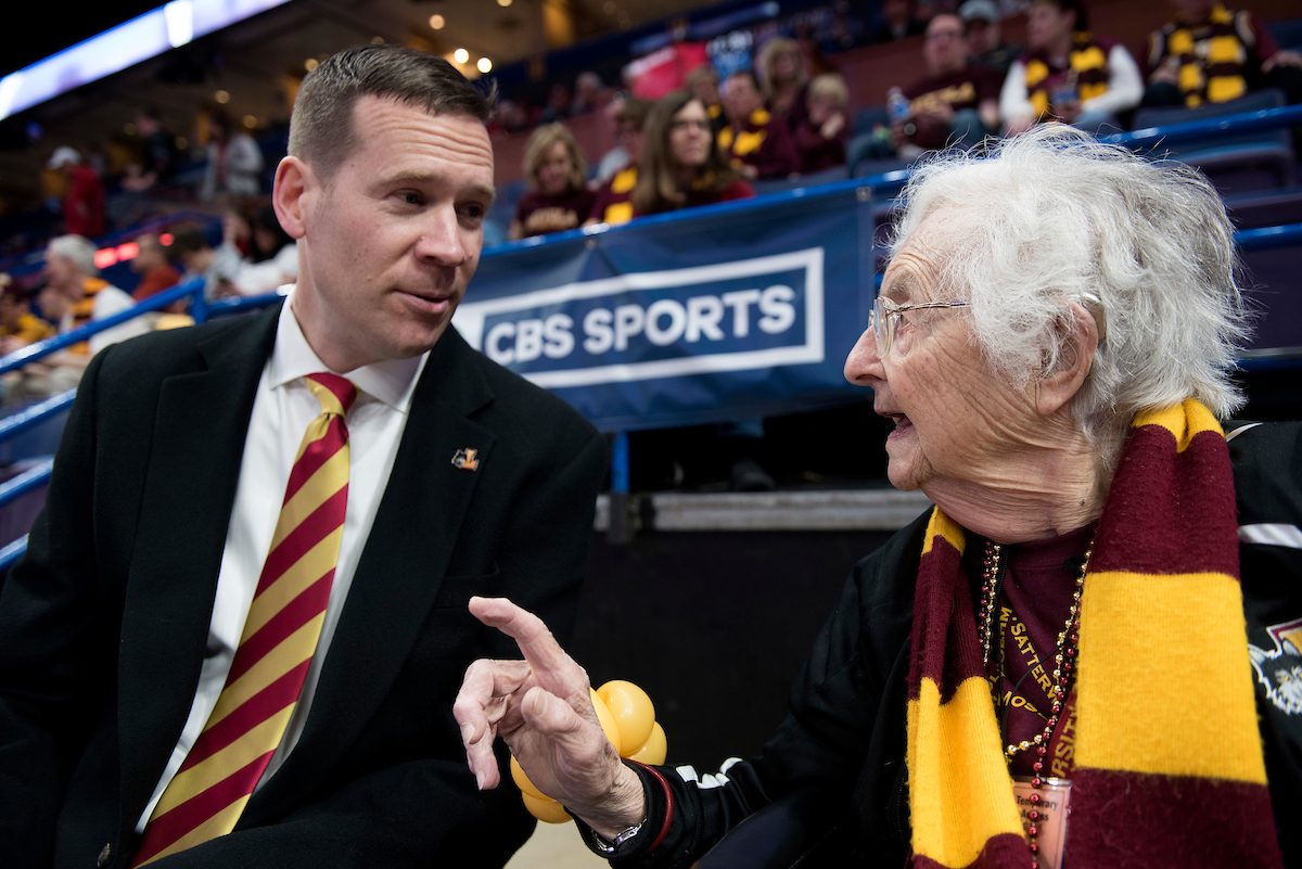 Loyola University Chicago Athletics Director Steve Watson talks with Sister Jean Dolores Schmidt, BVM, before the Ramblers' battle Illinois State University during the championship game of the Missouri Valley Conference men's basketball tournament at Scottrade Center in St. Louis Sunday, March 4, 2018. (Photo: Sid Hastings)