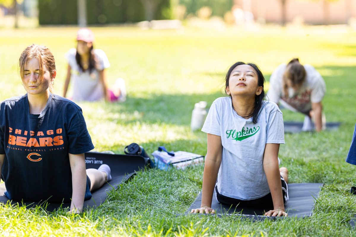 Loyola University Chicago students practice yoga during Yoga on the Quad during Welcome Week, August 31, 2024. (Photo by: Lukas Keapproth)