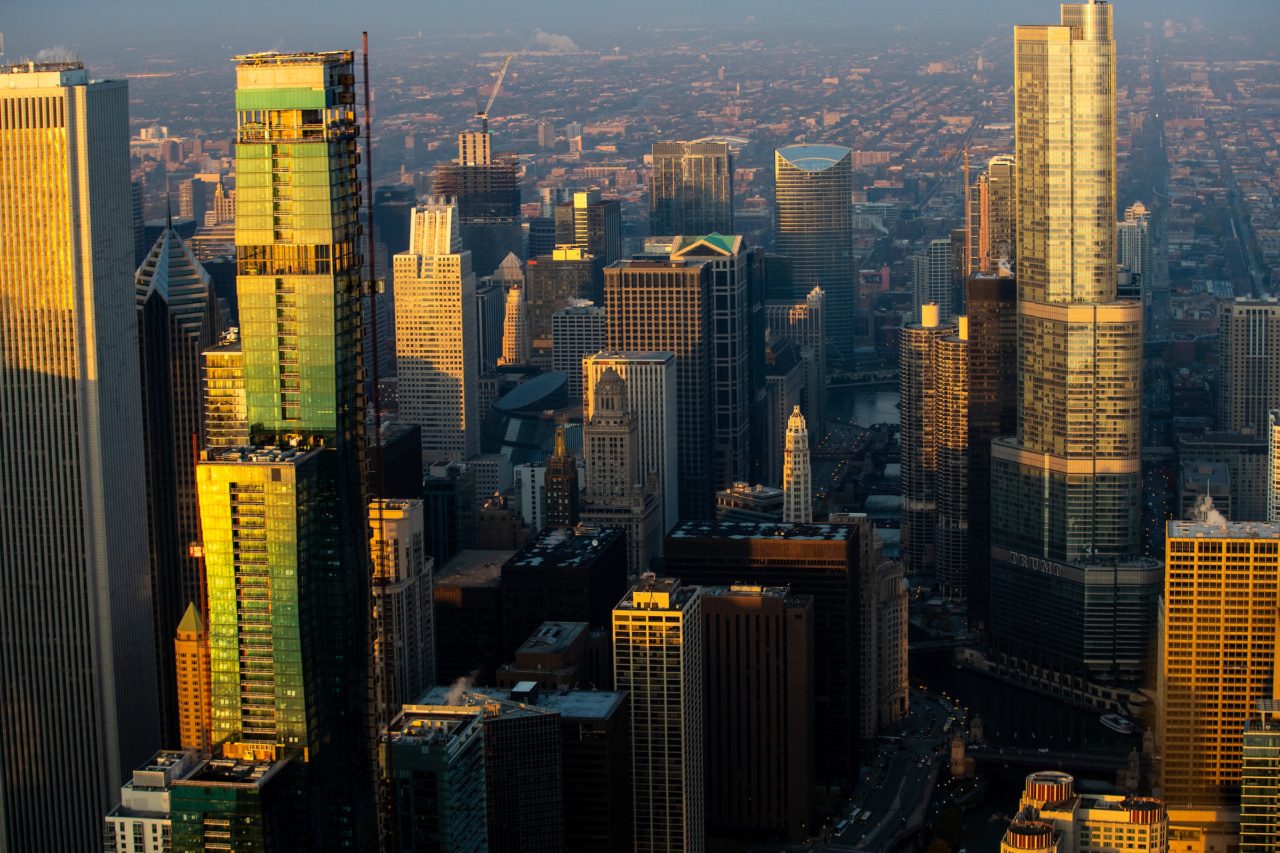 High rises reflect golden light from a sunset in downtown Chicago