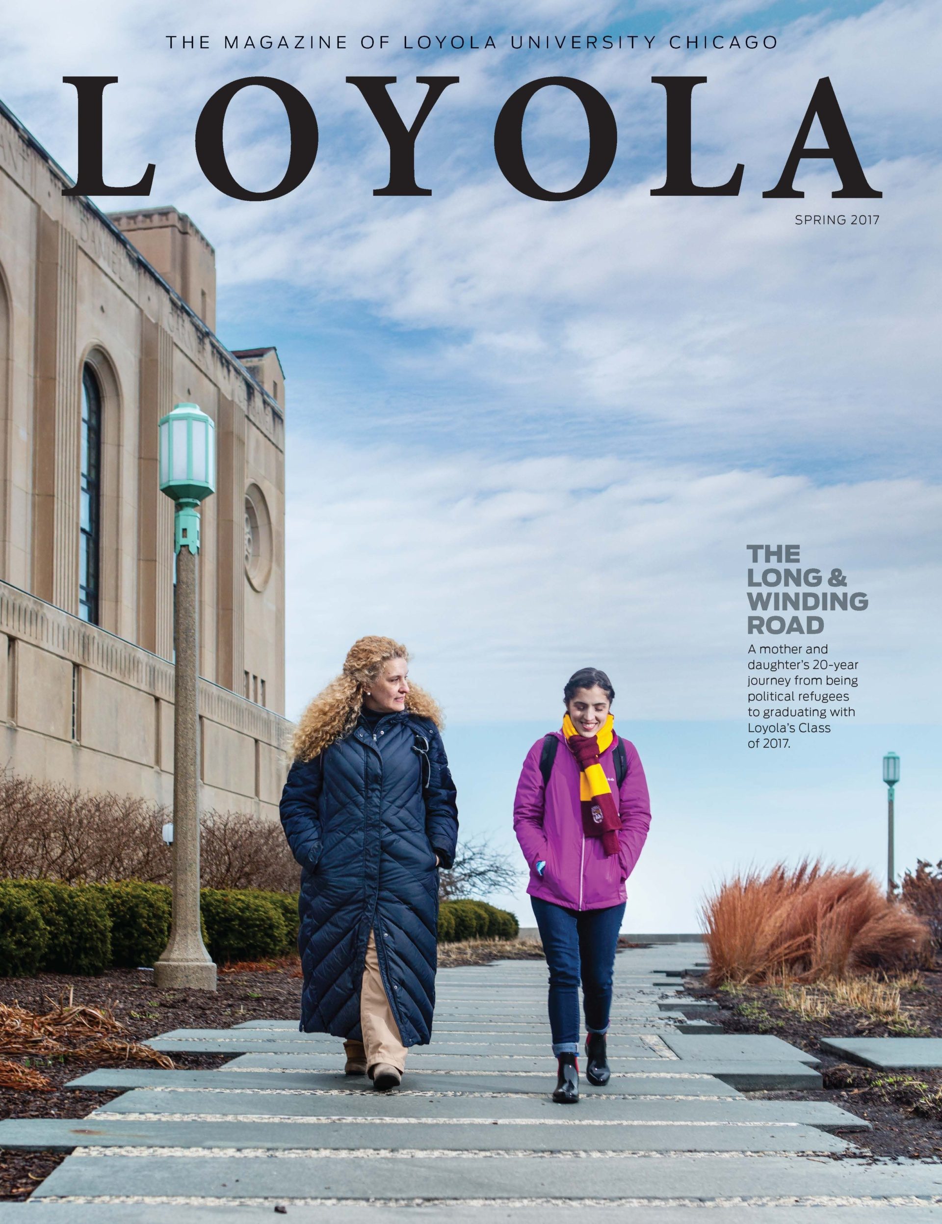 An older and younger woman walk on a stone path on Loyola University Chicago's campus with the chapel in the background on this magazine cover