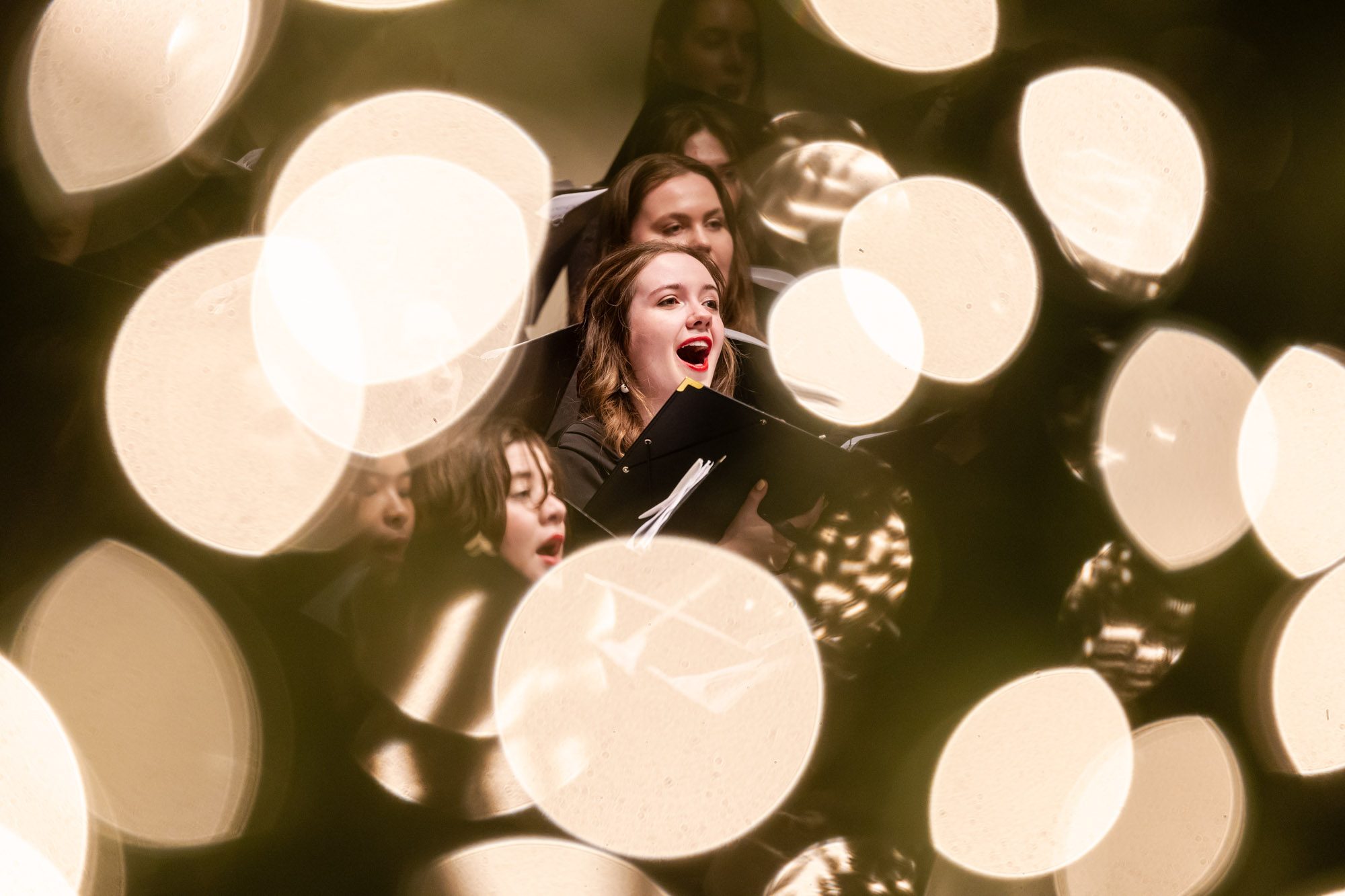 The Loyola chorus ensemble performs at Lessons and Carols, a holiday service that combines scripture readings with liturgical music in Madonna Della Strada Chapel, December 7, 2024. (Photo: Lukas Keapproth)