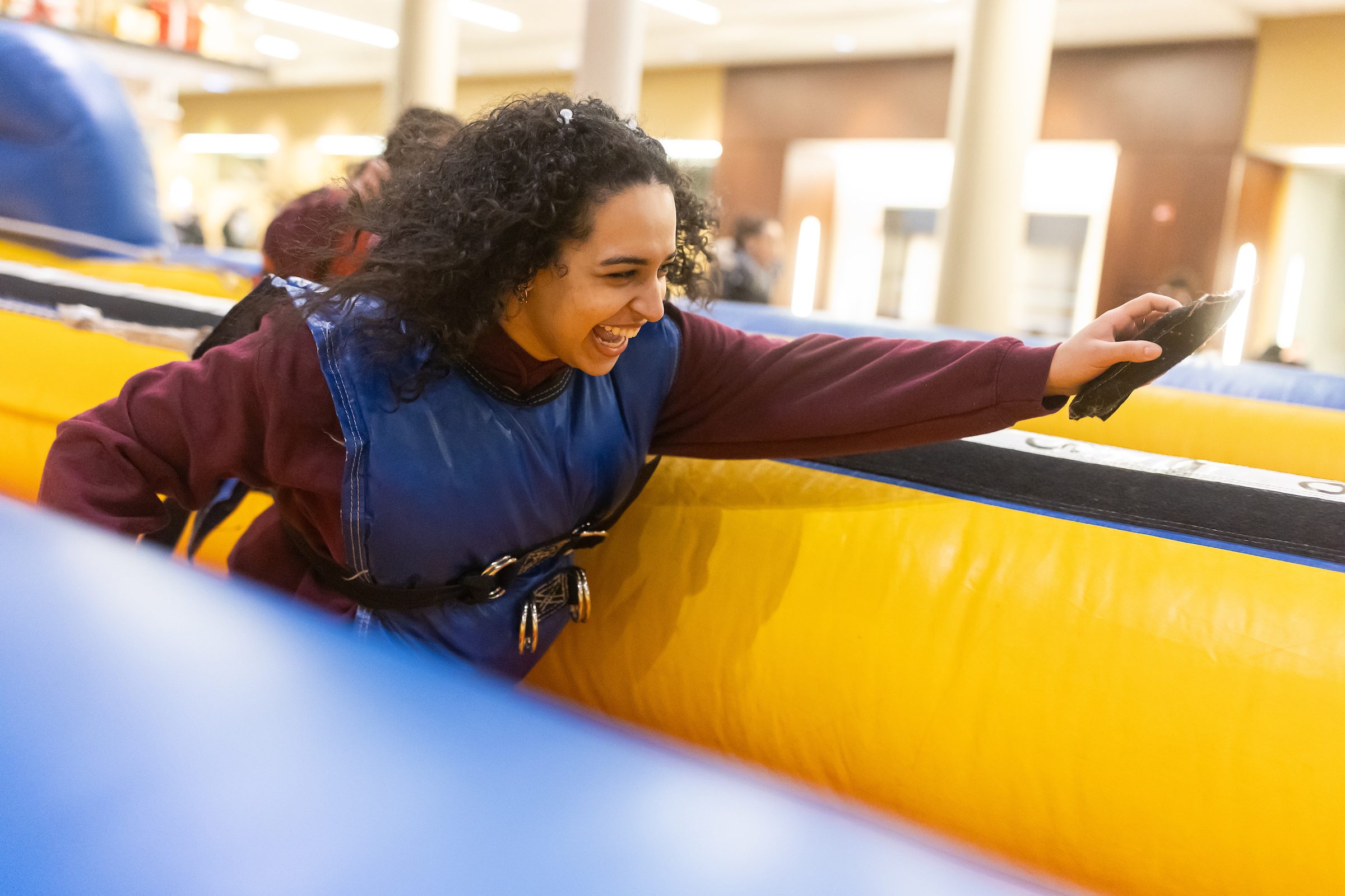 This year’s Jesuit Jam event featured an inflatable bungee run, a Connect 4-style basketball game, and an interactive bingo game. Loyola University Chicago students compete in an inflatable bungee run.