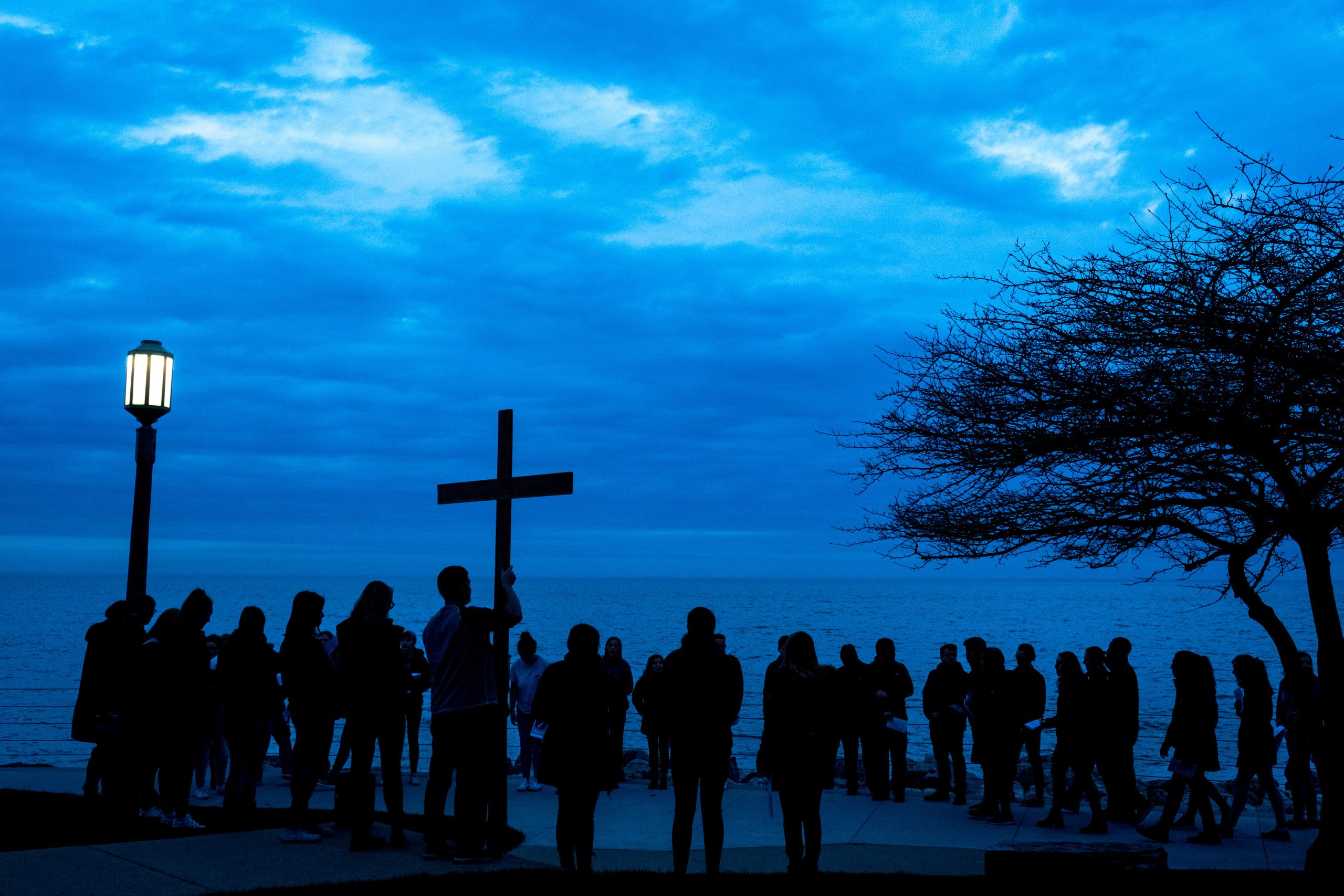 Loyola University Chicago staff and students participate in Via Crucis, which symbolizes the final path Jesus took before being crucified. Students complete the mini "pilgramage" around the Lake Shore Campus accompanied by songs and prayers for forgiveness and compassion for the immigrant community. (Photo: Lukas Keapproth)