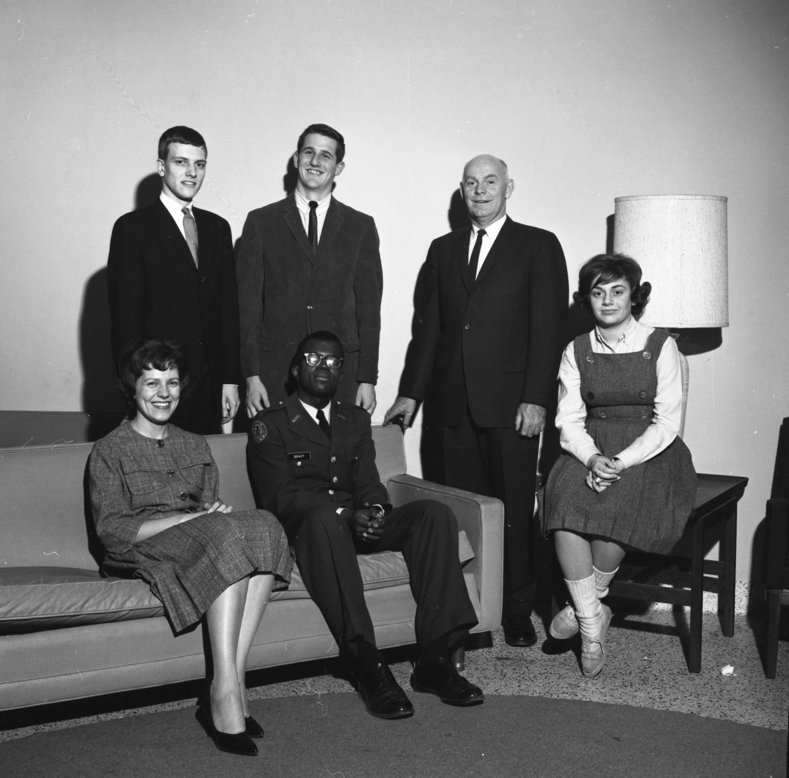 The 1963-1964 Loyola Debate Society and their faculty mentors pose for a photo on the Lake Shore Campus. (Courtesy photo/Loyola University Chicago Archives) The Loyola Debate society from the 1964-1965 school year poses for a photo, with some students sitting on a couch and some students standing.