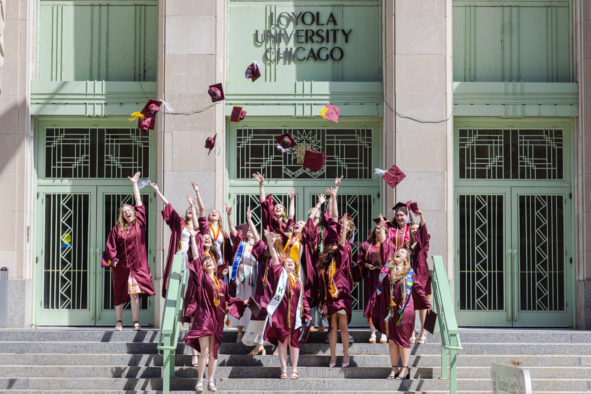 Graduates from the Department of Fine and Performing Arts toss their caps in the air in front of Mundelein Center for Fine and Performing Arts after their commencement ceremony on May 9.