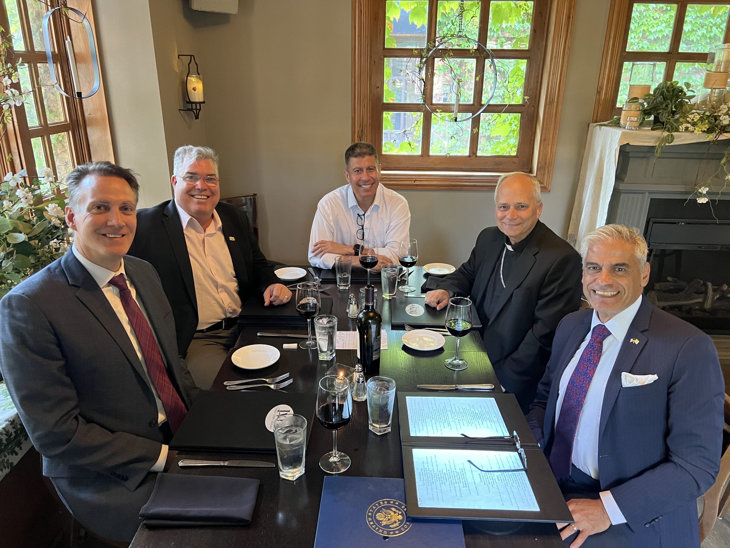 Loyola theologians have dinner with Pope Leo XIV (then Cardinal Robert F. Prevost, O.S.A.) at an Illinois restaurant in August 2024. From left: Interim Dean for the Institute of Pastoral Studies Peter Jones, Director of the Hank Center for the Catholic Intellectual Heritage and Senior Lecturer Michael Murphy, Clinical Assistant Professor Felipe de J. Legarreta, Pope Leo XIV, and John Courtney Murray, S.J. University Chair in Public Service Miguel Díaz. Photo courtesy of Miguel Díaz.
