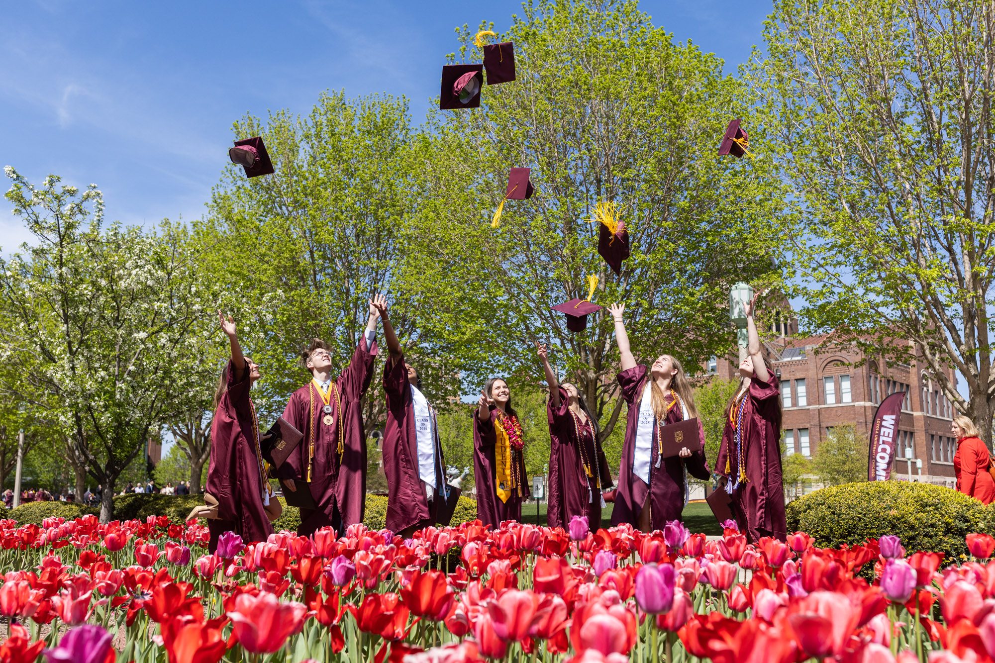 Graduates from the Parkinson School of Health Sciences and Public Health toss their caps in the air after their commencement ceremony on May 7.