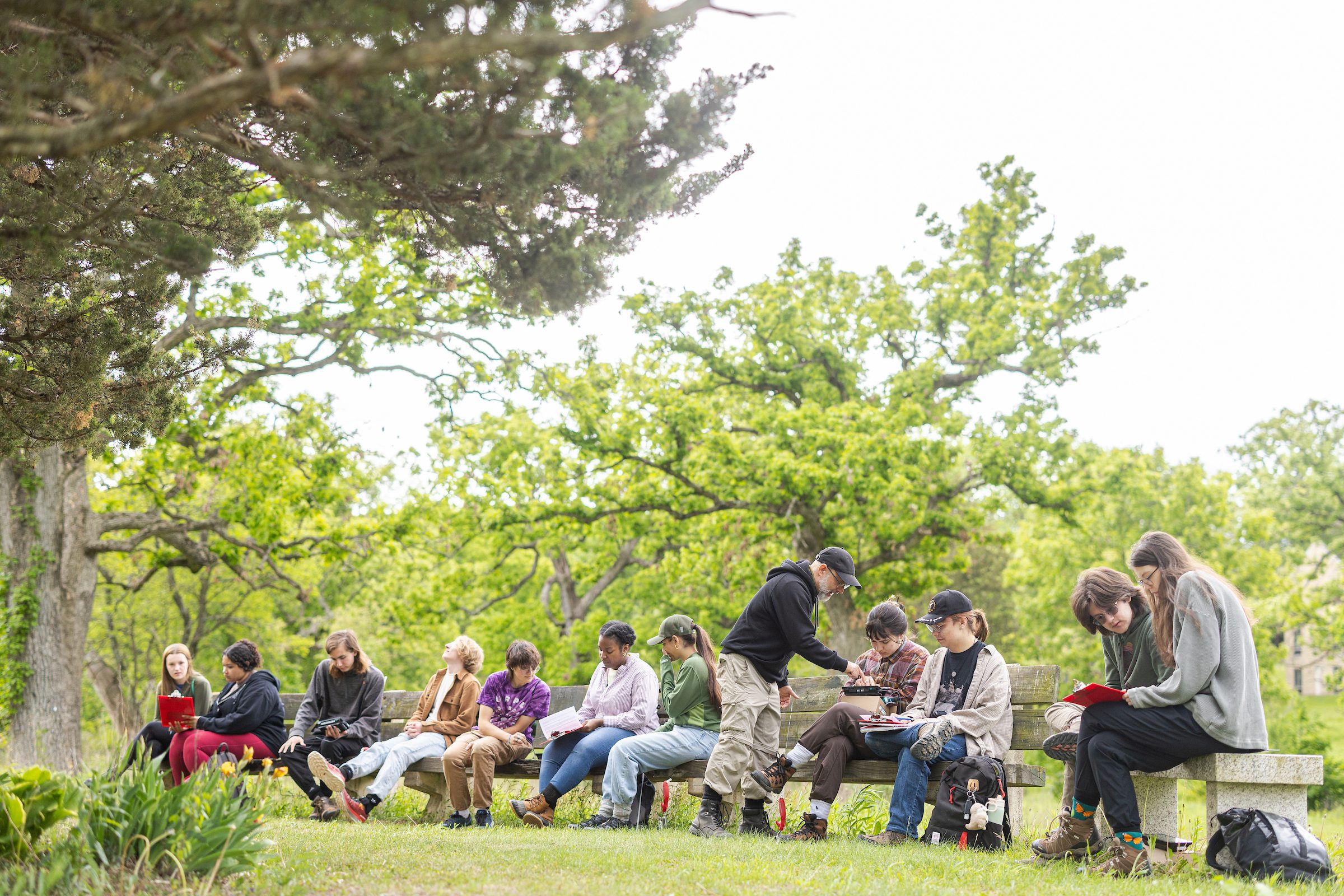 Ray Dybzinski, associate professor in the School of Environmental Sustainability, shows students how to use equipment that measures soil and plant respiration, among other ecological skills.