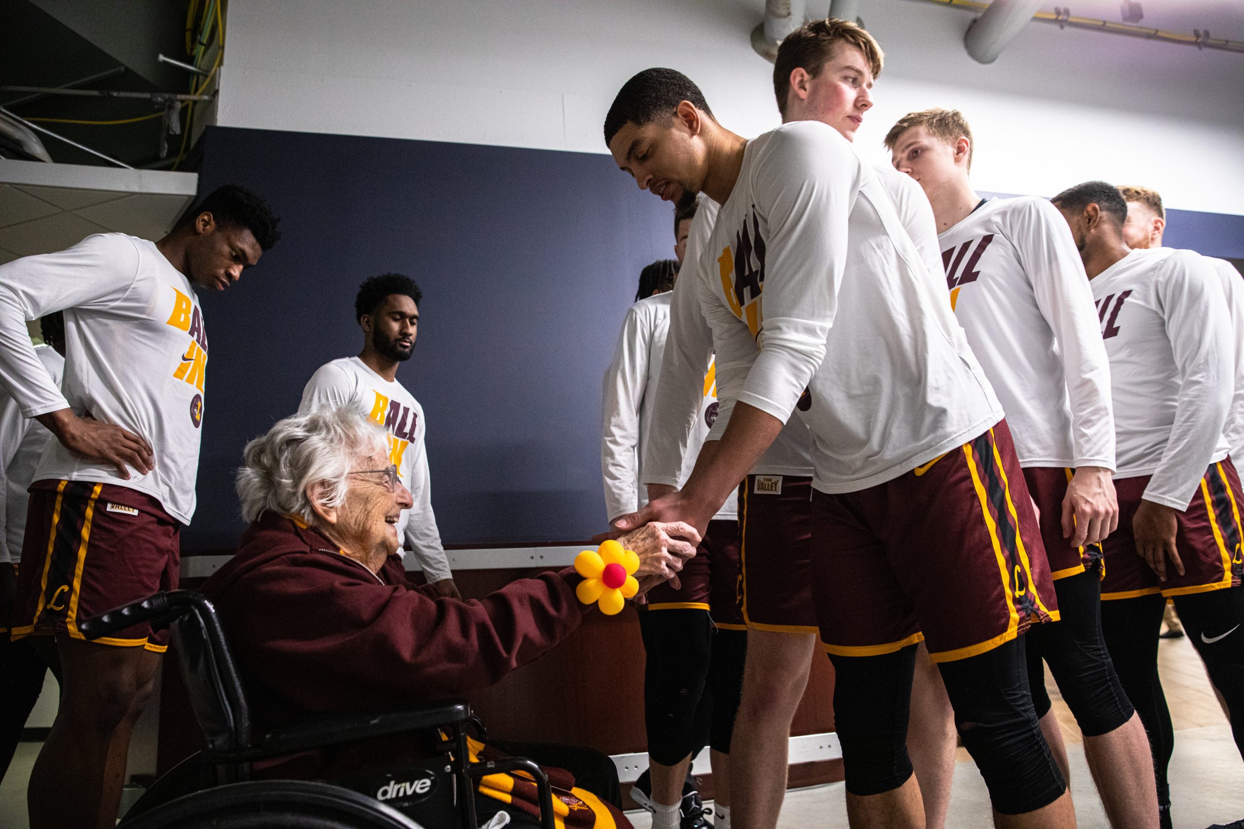 Ramblers men's basketball player Lucas Williamson shakes hands with Sister Jean Dolores Schmidt after she gave her pre-game prayer ahead of the MVC Tournament championship game against Drake in 2022.