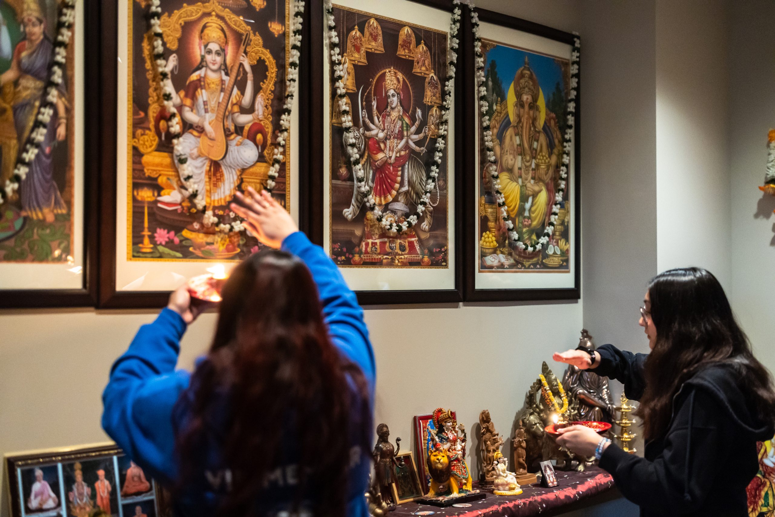 Members of the Hindu Student Association participate in a ceremony in the puja room in the Damen Student Center.