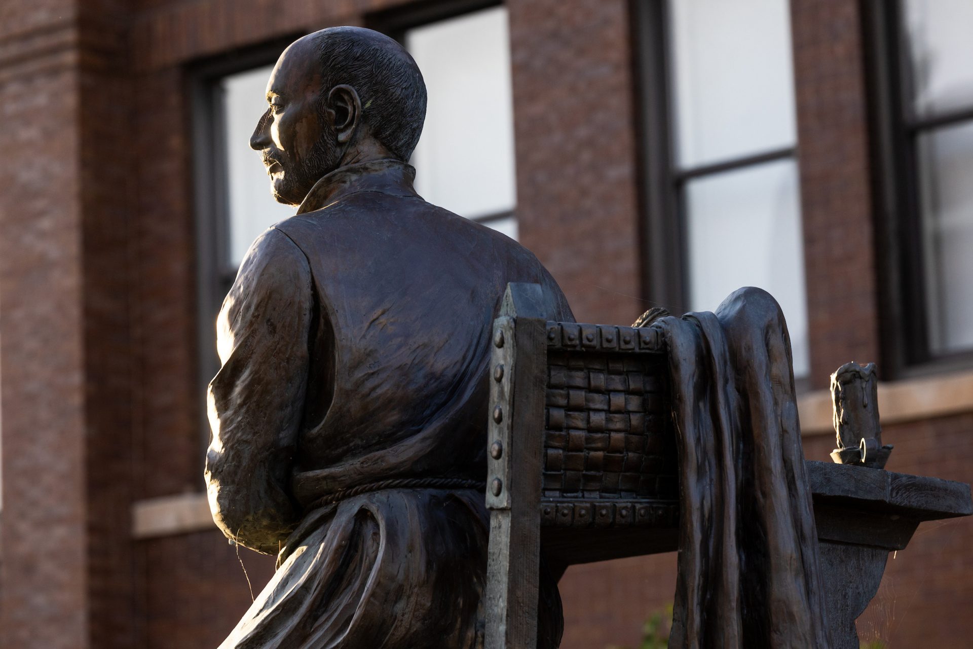 A statue of a man sitting in a chair