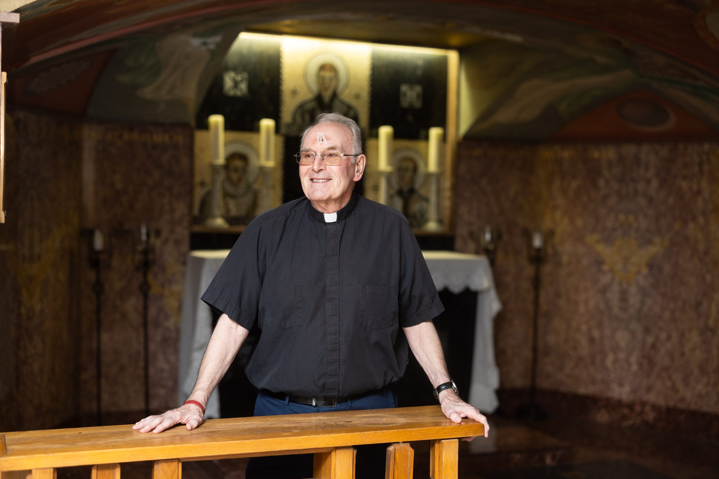 Father Jerry Overbeck stands in front of one of the altars inside Madonna Della Strada's crypt.