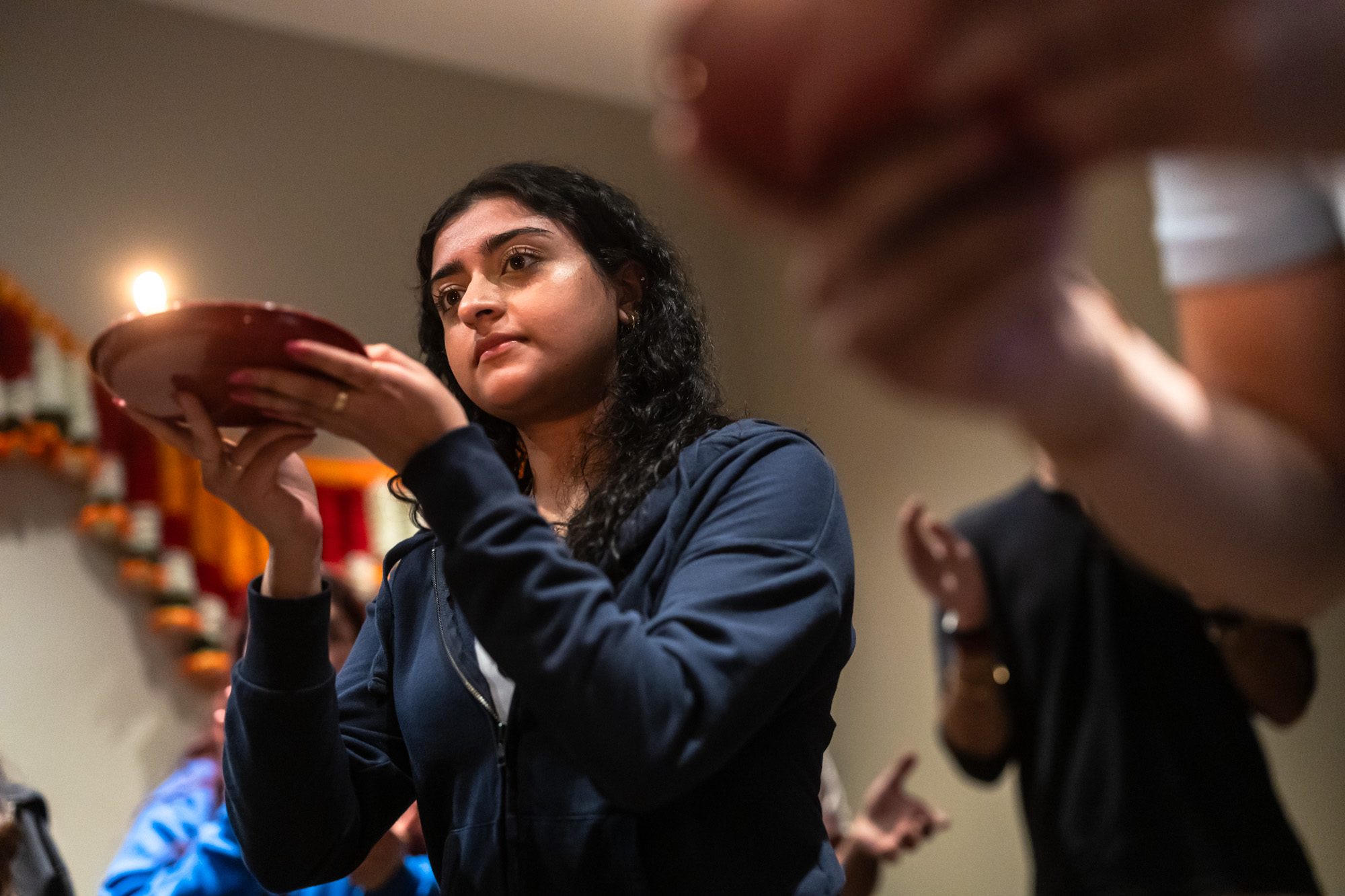 Members of the Hindu Student Association participate in a ceremony in the puja room in the Damen Student Center.
