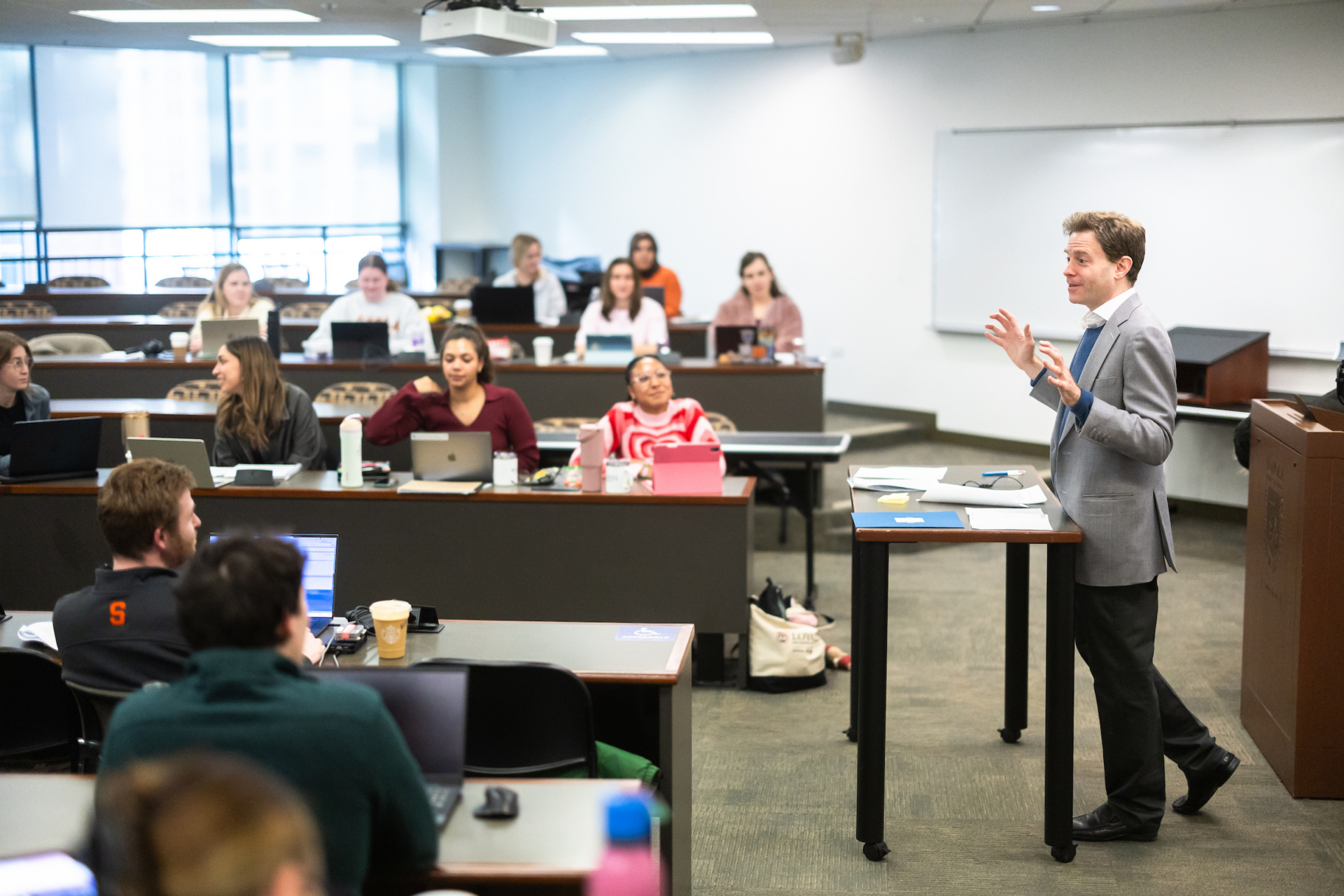 A Loyola University Chicago professor instructs in a classroom while law students listen
