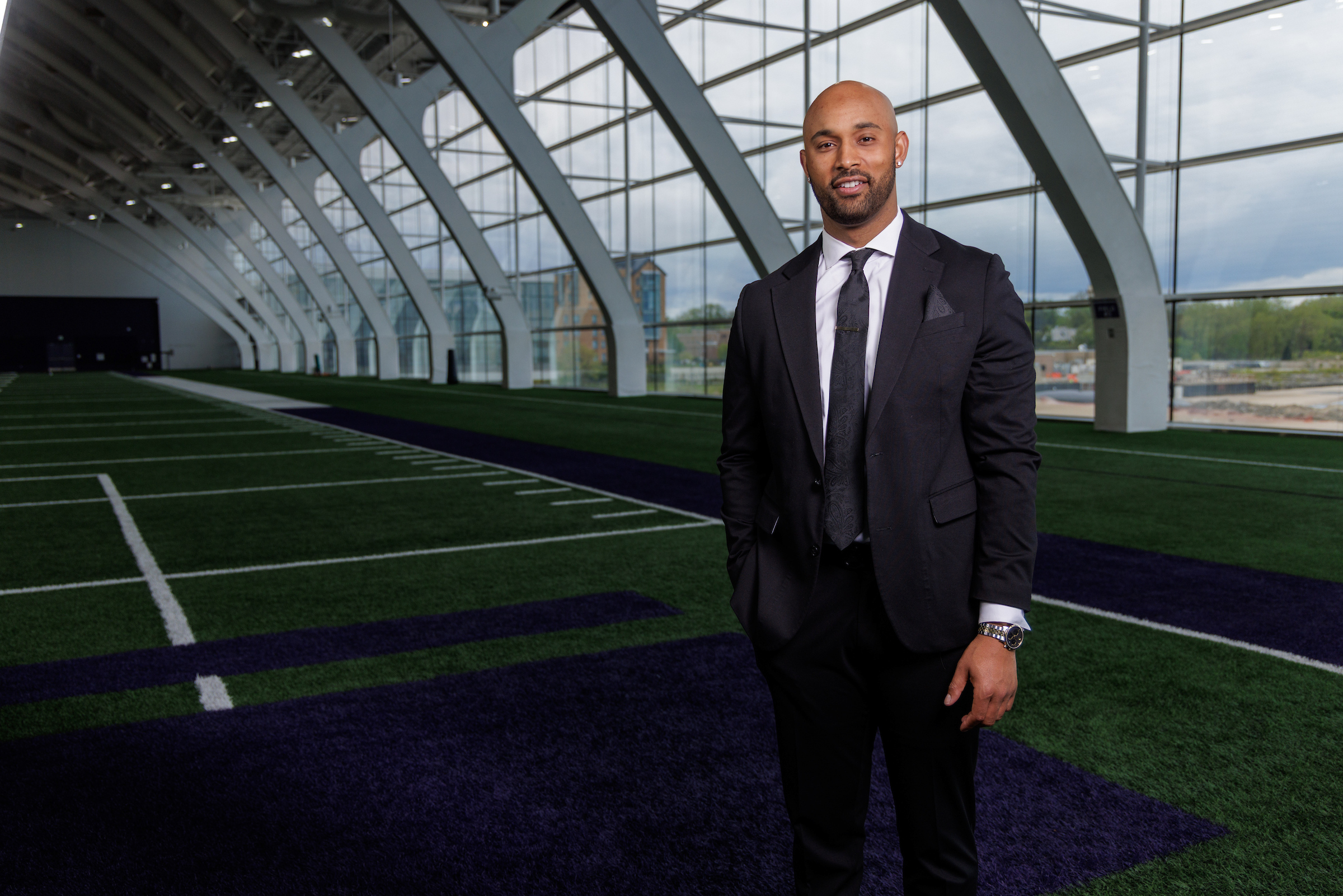 Noor Davis, a Loyola Law School graduate who works for the Chicago Bears stands on a turf field on May 22, 2025.
(Photo by Charles Cherney)