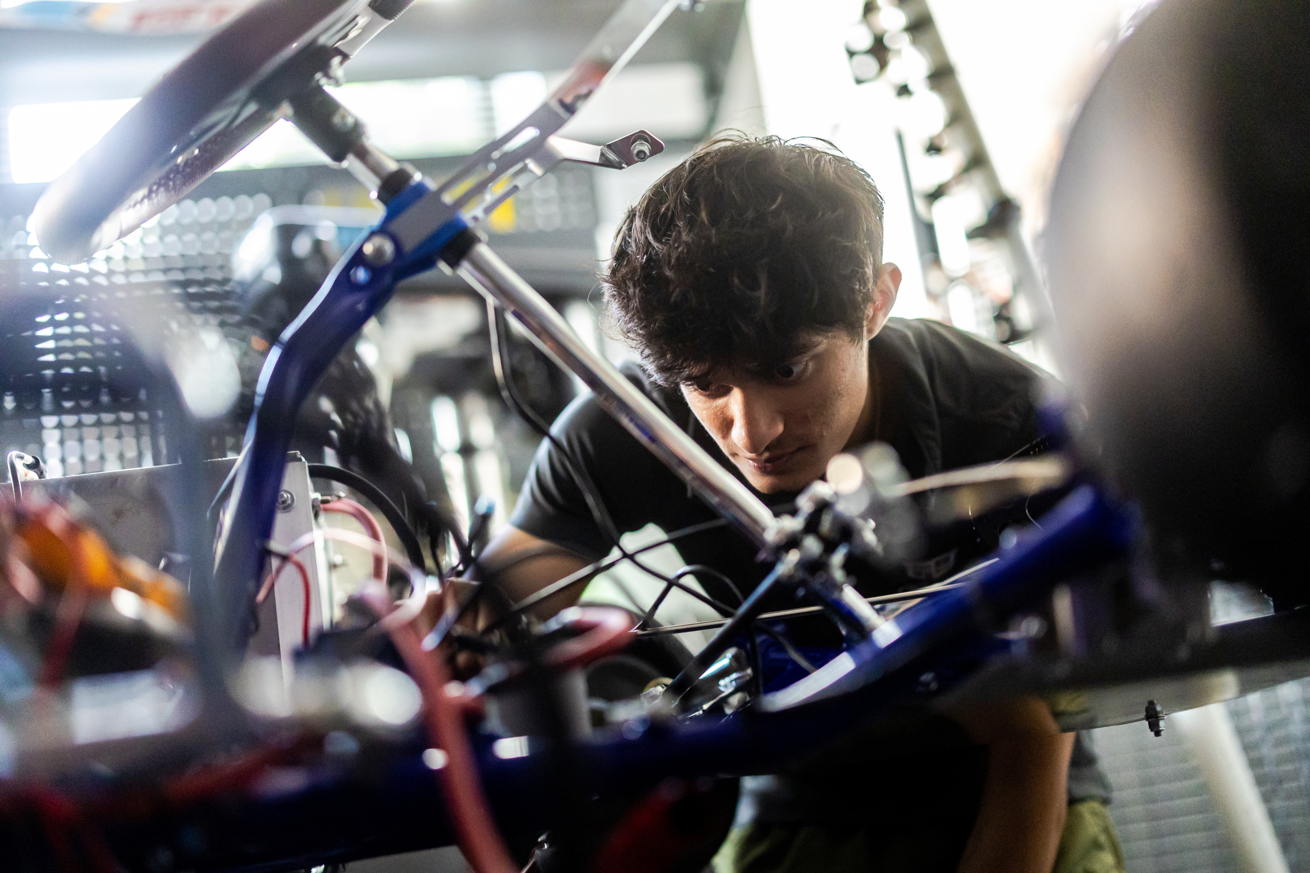 Jayson Shah works on the team's electric go-cart in the Loyola Vehicle Lab.