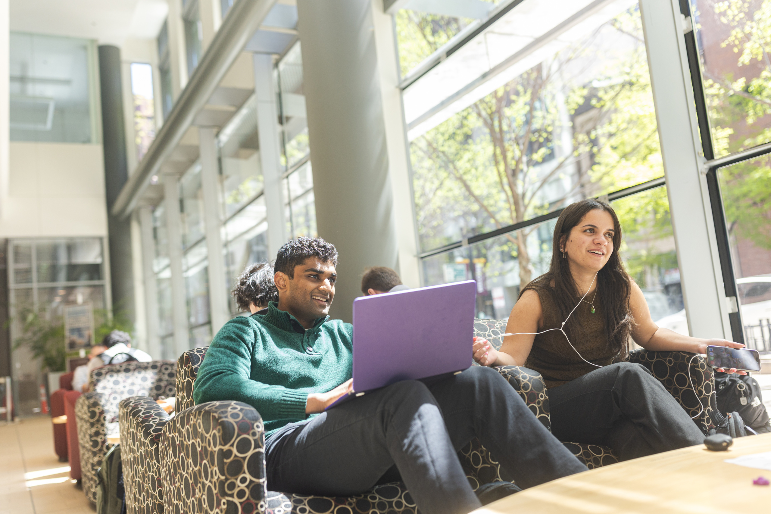 Quinlan School of Business students hang out in the lobby of the Schreiber Center between classes. 