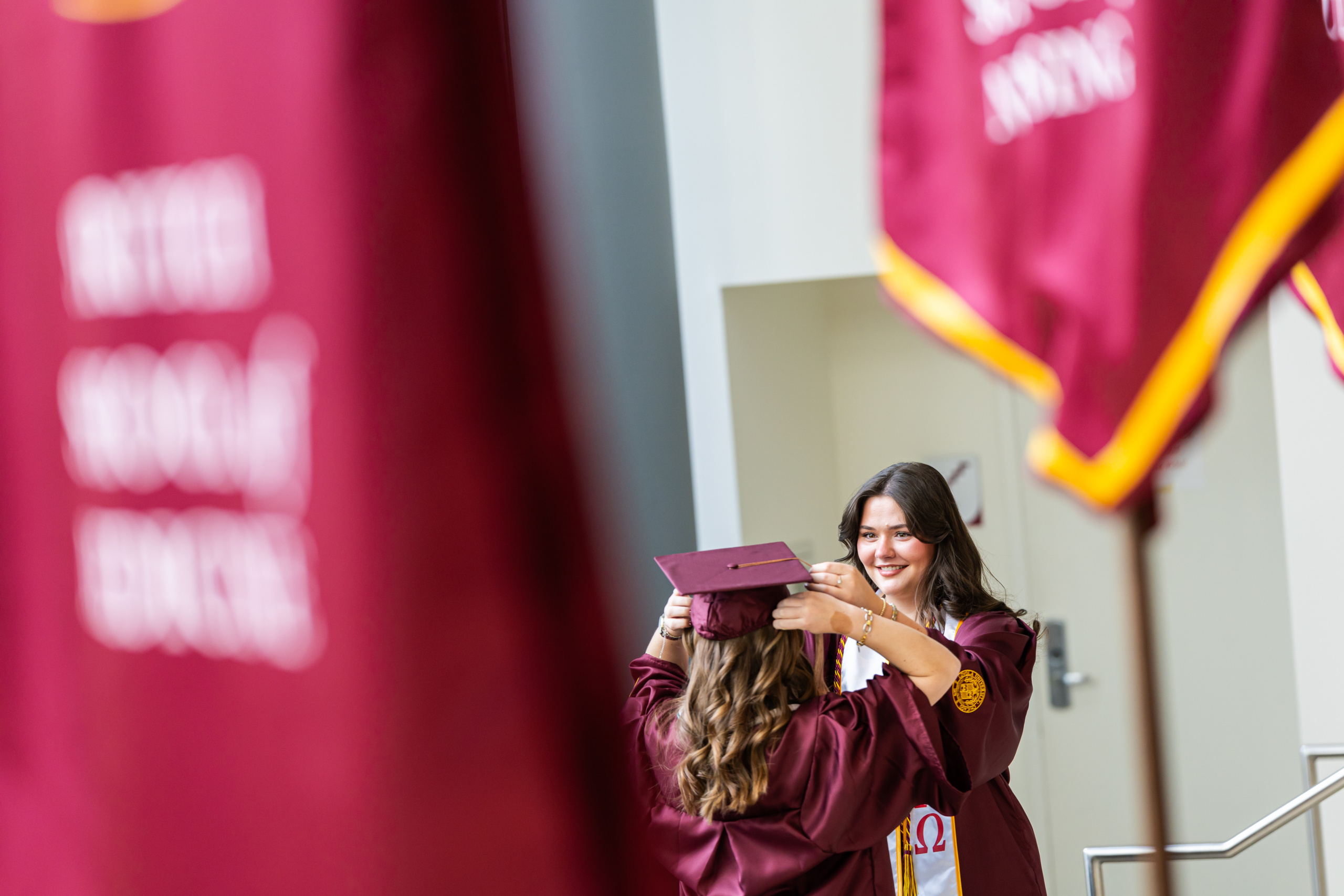 Loyola University Chicago graduates from the Quinlan School of Business prepare to attend their commencement ceremony in Gentile Arena on May 7, 2026. Juliana Pidner Hsu (MBA '18) was the keynote speaker.