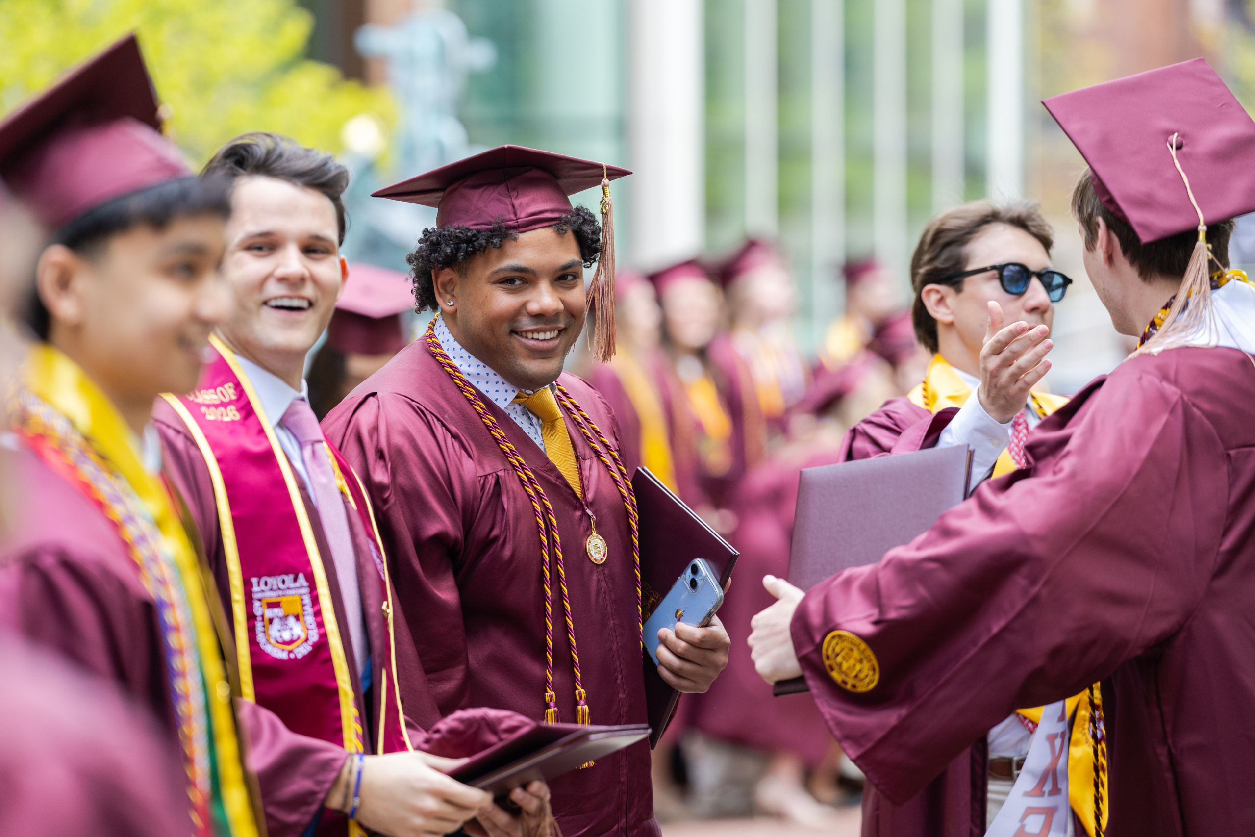 Loyola University Chicago graduates from the Quinlan School of Business celebrate after their Commencement ceremony on Loyola's West Quad on May 7, 2026.
