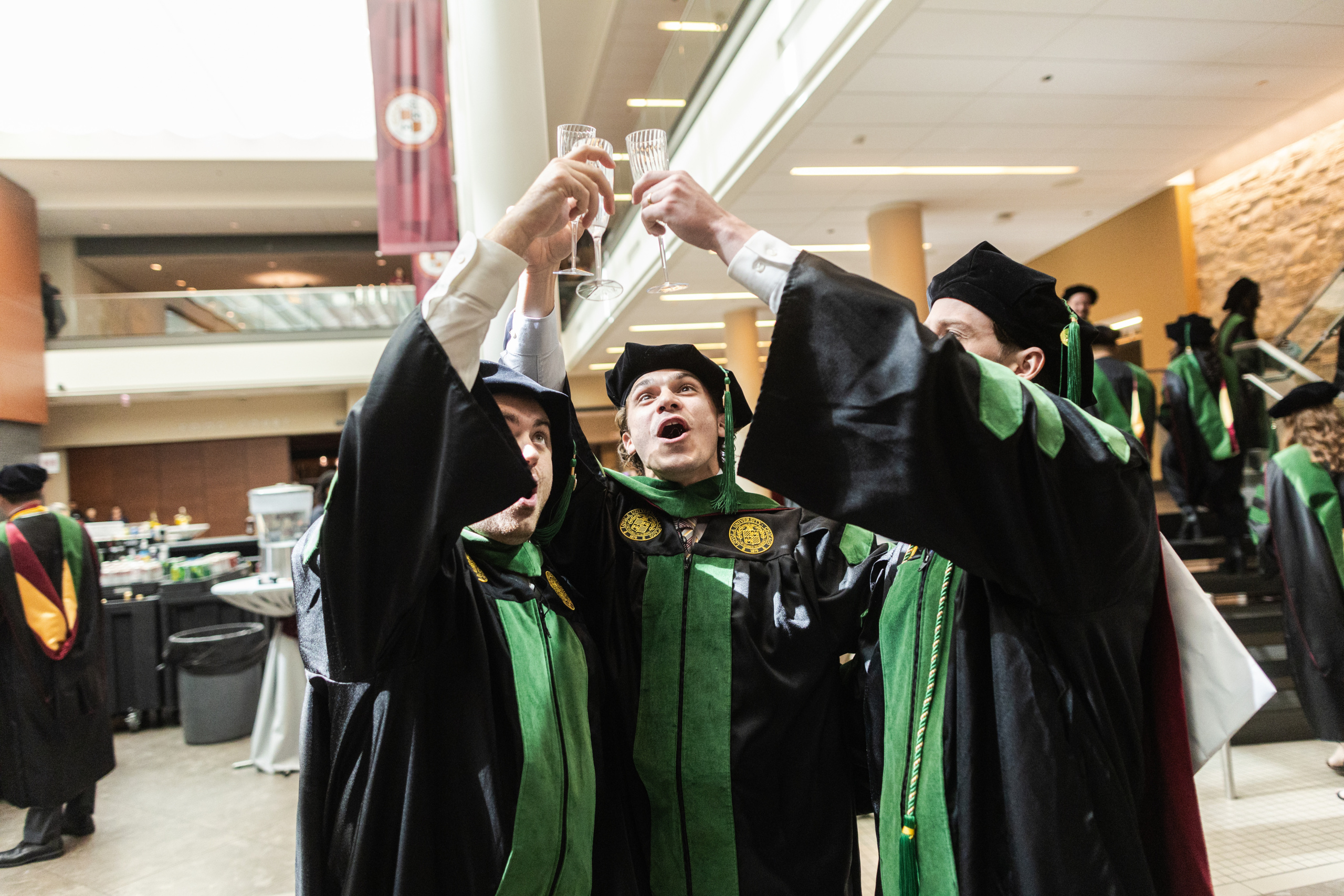 Dean Marzo leads Stritch School of Medicine graduates in a toast following their commencement ceremony.