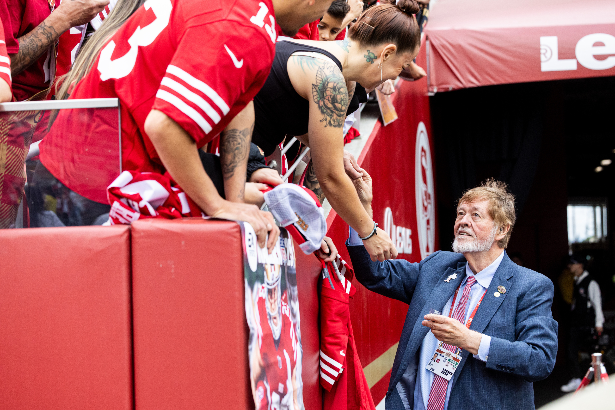 John York, right, shakes hands with a San Francisco 49ers fan at Levi's Stadium® in September 2025. Part of York's legacy is his investment in the 49ers Foundation, which prepares students from disinvested communities for college success.