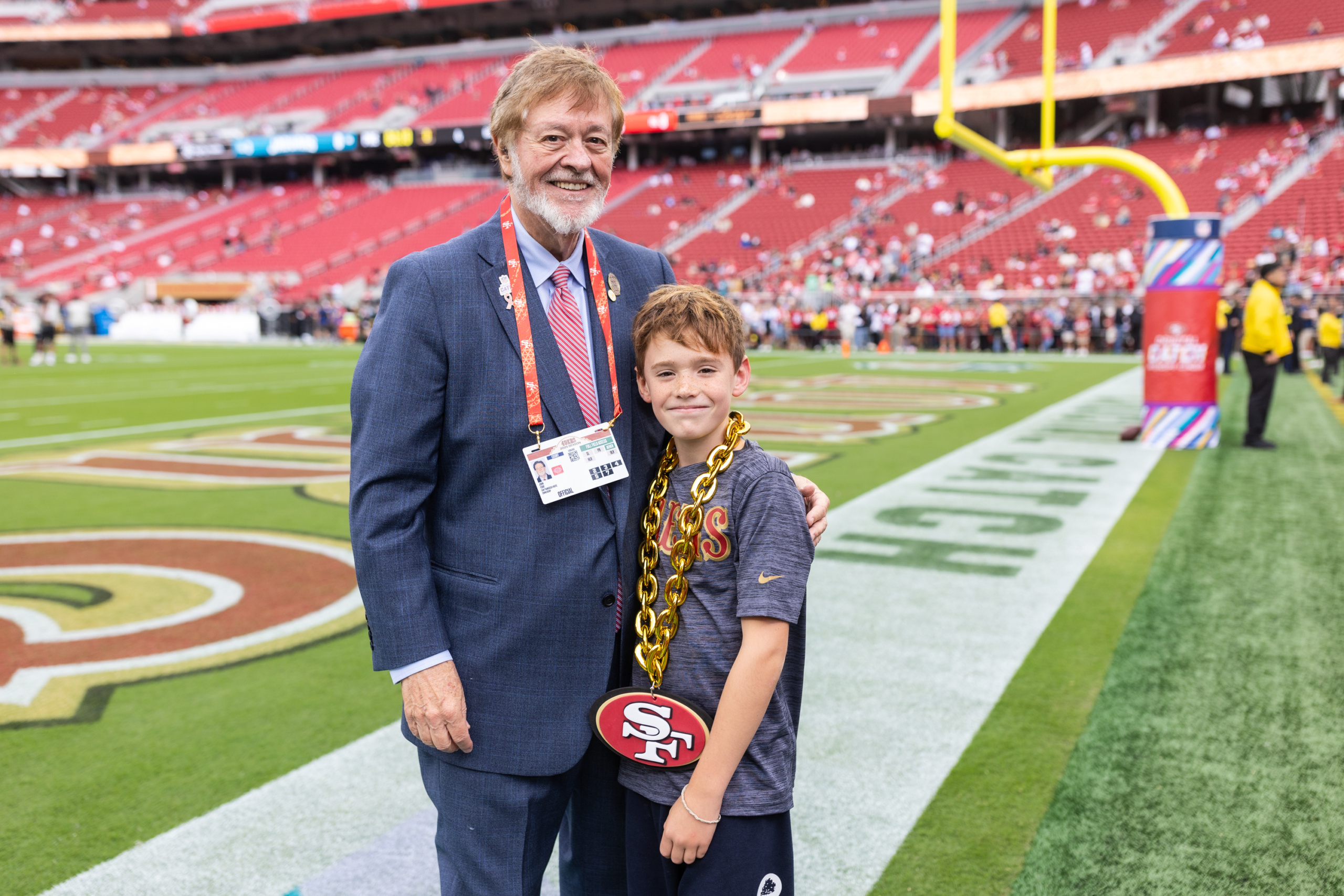 John York and his grandson spend some time on the field before a San Francisco 49ers game at Levi's® Stadium in September 2025.