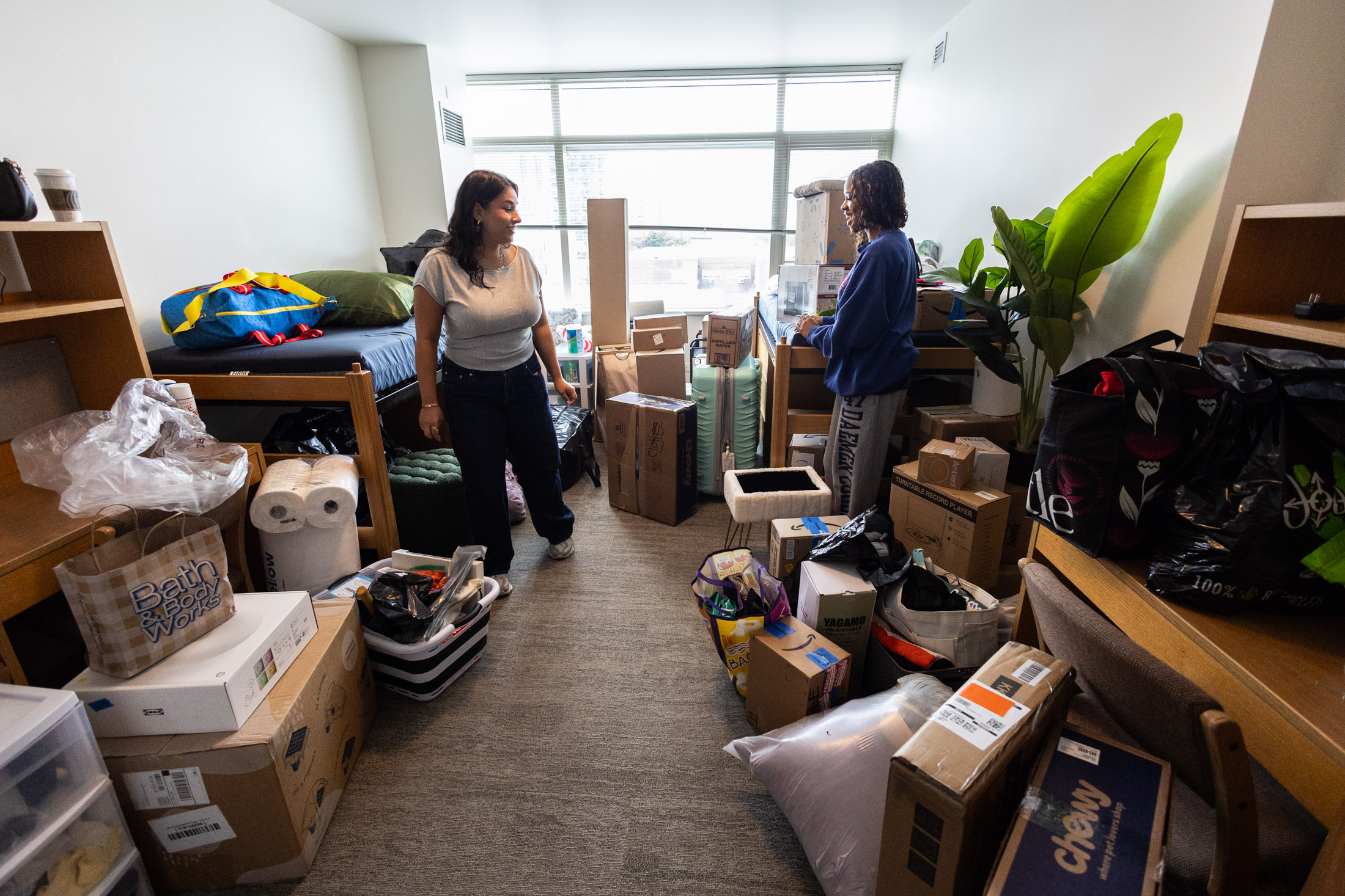 Mia Dominguez (left) and Jordyn Houston unpack their dorm room in San Francisco Hall. 