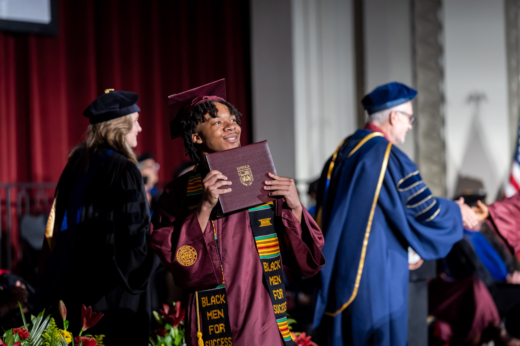 Arrupe College graduates and their friends and family celebrate commencement in Jo Ann Rooney Auditorium. Michèle Alexandre, JD, dean of Loyola University Chicago School of Law, delivered the commencement address.