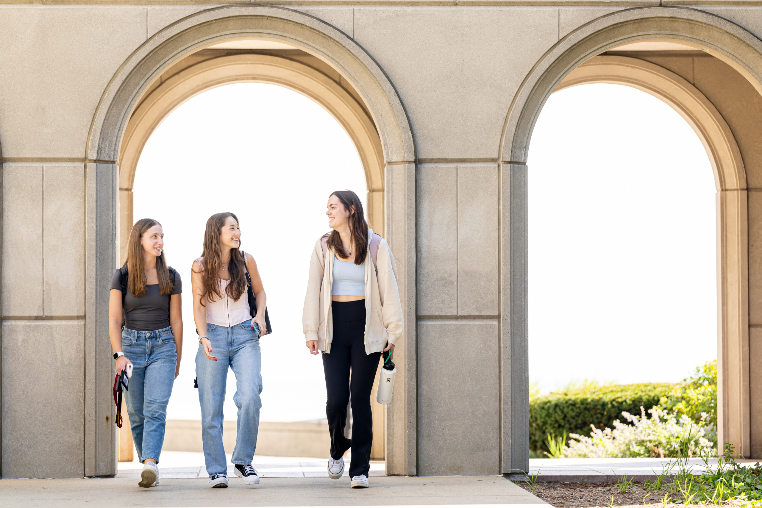 Nora Lenham, Riley Regnier, and Lydia Bir walk to classes on the first day of their freshmen year, August 28, 2023. (Photo: Lukas Keapproth)